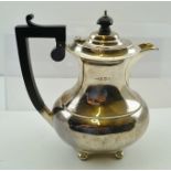 GREENBURG & CO. AN OBLONG SILVER BALUSTER HOT WATER POT, having black fibre knop and handle,