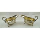 HARRISON BROS. A PAIR OF GEORGIAN STYLE SILVER SAUCE BOATS having up-scrolled handles, gadroon