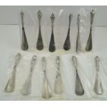 A COLLECTION OF TWELVE SILVER HANDLED STEEL SHOE HORNS, with pressed foliate and floral