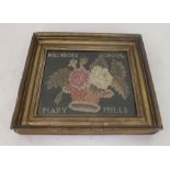 A LATE VICTORIAN WOOLWORK PICTURE of a basket of flowers, inscribed "Hunden School, Mary Mills" in a