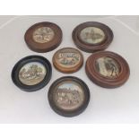 A COLLECTION OF SIX PRATTWARE POT LIDS, various subjects, each mounted in a turned wood frame,