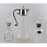 TWO 20TH CENTURY CUT GLASS SCENT BOTTLES, with silver mounted collars and steeple stoppers,