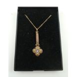 A VICTORIAN MICRO MOSAIC GOLD MOUNTED PENDANT, comprising a floret with salmon pink, olive green,