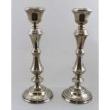 A PAIR OF MID 20TH CENTURY SILVER CANDLESTICKS, having ring turned knop stems on circular platform