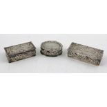 THREE LATE 20TH CENTURY SILVER PILL BOXES of Victorian design, repousse decoration, the