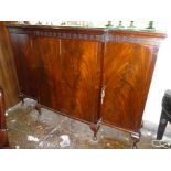 AN EDWARDIAN MAHOGANY VENEERED BREAKFRONT SIDEBOARD with blind fret frieze raised on cabriole