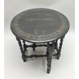 AN EDWARDIAN CARVED EBONISED SMALL DROPLEAF OCCASIONAL TABLE raised on barley twist framed supports,