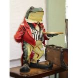 A POLYCHROME DECORATED MODEL FROG FOOTMAN in striped waistcoat holding a gilt coloured circular tray