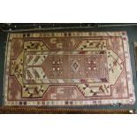 TWO TRIBAL RUGS, pink ground with stylised designs, largest 105cm x 185cm