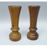 A PAIR OF TREEN VASES of fluted form, ring turned with circular bases, 22cm high