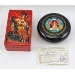 A RUSSIAN RED LACQUERED BOX hand-painted with Warrior decoration to the lid, signed and inscribed,