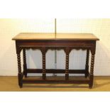 A PART 18TH CENTURY OAK SIDE TABLE with shaped frieze, raised on bobbin turned supports, the plank