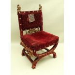 A LATE 19TH CENTURY X-SHAPED THRONE STYLE CHAIR with carved lion finials supporting shields