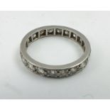 A DIAMOND SET ETERNITY RING, set in white gold or platinum, size O easy