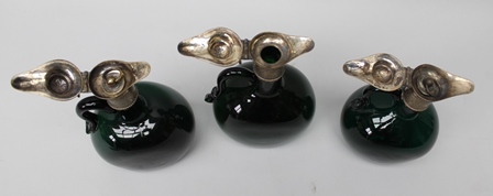 A GRADUATING TRIO OF GEORGIAN GREEN GLASS SPIRIT JUGS with plated mounts, (two with original - Image 2 of 3