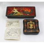 A RUSSIAN LACQUERED BOX hand-painted with firebird decoration, the hinged cover opening to reveal