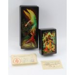 A RUSSIAN LACQUERED BOX hand-painted with firebird decoration, the hinged cover opening to reveal