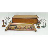 AN EARLY 20TH CENTURY TABLE OR CARPET CROQUET SET comprising mallets, balls, hoops etc., in