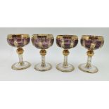 A SET OF FOUR MOSER STEMMED CRYSTAL LIQUEUR GLASSES, amethyst panel shallow bowls, gilded, upon