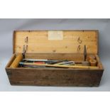 A MID 20TH CENTURY CROQUET SET in stained pine box