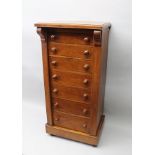 A 19TH CENTURY MAHOGANY WELLINGTON CHEST, fitted seven drawers, raised on box base with castors,
