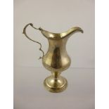 A GEORGE III SILVER PEDESTAL CREAM JUG having bead rim, baluster body and circular foot, marks