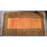 A TRIBAL RUG, orange ground with black geometric deep border, 105cm x 184cm