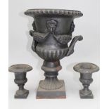 A 20TH CENTURY CAST IRON CAMPAGNA SHAPED TWO-HANDLED URN with swag decoration in relief on a
