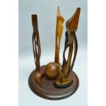 A COMTEMPORARY WOODEN SCULPTURE "MACBETH", featuring the witches about a central ball, 39.5cm high