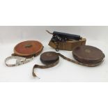 A "STANLEY" OF LONDON SURVEYING INSTRUMENT in leather case and THREE LEATHER CASED SURVEYOR'S TAPE