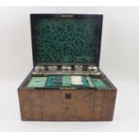 A 19TH CENTURY WALNUT VENEERED DRESSING BOX with Tunbridge style inlay, opens to reveal a fitted