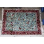 A 20TH CENTURY PERSIAN RUG having central blue field with all over hunting scene, archers on