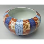 A JAPANESE CERAMIC BOWL, decorated in the Imari taste, bands of cobalt blue on iron red, gilded,