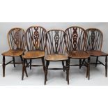 A MATCHED SET OF FIVE PROVINCIAL WHEELBACK SINGLE CHAIRS circa 1900, with shaped elm seats, on