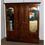 AN EDWARDIAN MAHOGANY TRIPLE WARDROBE having inlaid geometric line decoration, Greek key frieze