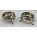 DAVID HENNELL A PAIR OF GEORGE II SILVER SALTS, having floral embossed and chased decoration, raised