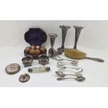 A COLLECTION OF SILVER WARES, including spoons, pair of salts, pair of fluted form bud vases and