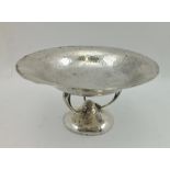 WALKER & HALL AN ARTS & CRAFTS DESIGN HAMMERED SILVER COMPORT, on three cast Art Nouveau supports to