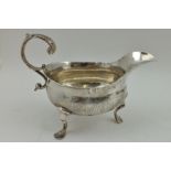 THOMAS SHEPHERD A GEORGE III SILVER SAUCE BOAT, having acanthus scroll handle, on three feet, London