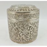 AN EASTERN WHITE METAL CANISTER with cover, ornately decorated floral and acanthus leaves, 7.5cm