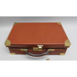 A CONWAY OF LONDON BROWN LEATHER CARTRIDGE CASE with brass mounts, fitted interior, key lock and