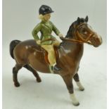 A MID 20TH CENTURY BESWICK POTTERY FIGURE, model no. 1499, girl wearing a green hacking jacket on