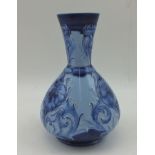 A "JAMES MACINTYRE & CO." FLORIAN WARE VASE, of tear drop form with flared neck, tube trailed floral