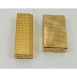 A "CARTIER" AND A "DUPONT" CIGARETTE LIGHTER, both in gilt metal textured effect finish (2)