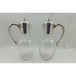 J. NOWILL & SONS A PAIR OF GEORGE V SILVER MOUNTED CLARET JUGS, each having plain collar with hinged