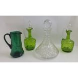 A PAIR OF VICTORIAN GREEN GLASS JUG DECANTERS, with clear ribbed handles and acorn finial