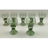 A SET OF SEVEN LATE 19TH CENTURY BAVARIAN GREEN GLASSES, the bowls engraved with the Heraldic