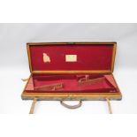 JAMES PURDEY & SONS, LONDON A FIRST HALF 20TH CENTURY LEATHER, OAK AND BRASS MOUNTED GUN CASE with