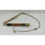 A BEAGLE WHIP, with carved bone hounds head whistle terminal to the malacca cane shaft