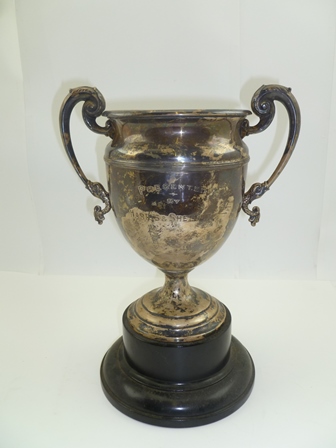 ADIE BROTHERS LTD A TWO-HANDLED SILVER TROPHY CUP, having acanthus leaf and cast dolphin handles,